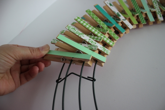 Step three arrange clothespins on wire wreath