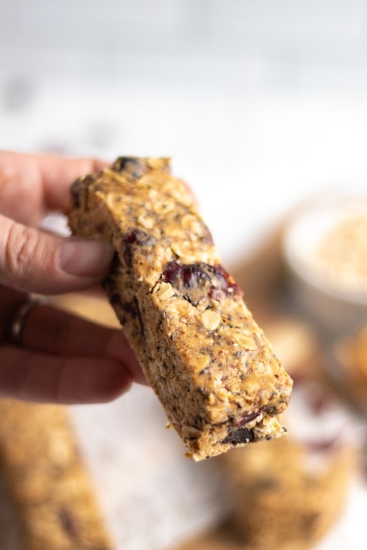Picking up a homemade granola bar with oats and cranberries Kitchen Cents recipe