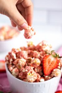 Pink popcorn flavored with strawberries and white chocolate. A recipe brought to you by Kitchen Cents