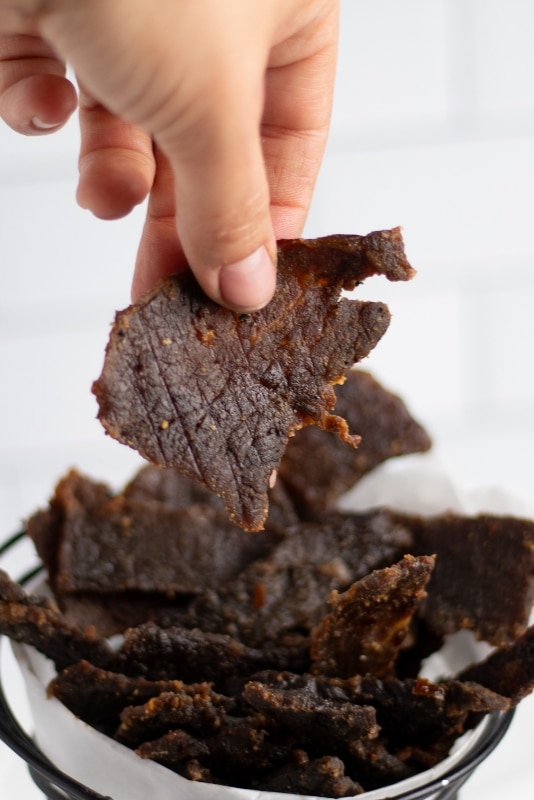 Enjoying a piece of Keto Beef Jerky for a snack