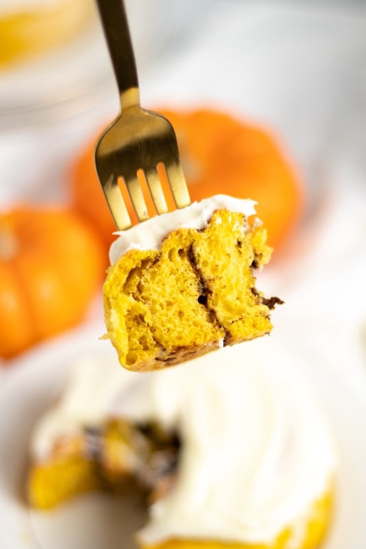 close up of single bite of pumpkin roll on a fork