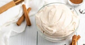 A bowl filled with cream cheese spiced frosting
