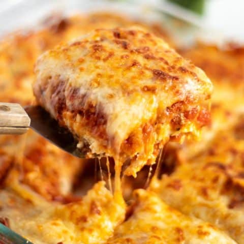 A slice of easy lasagna recipe being served from the baking dish