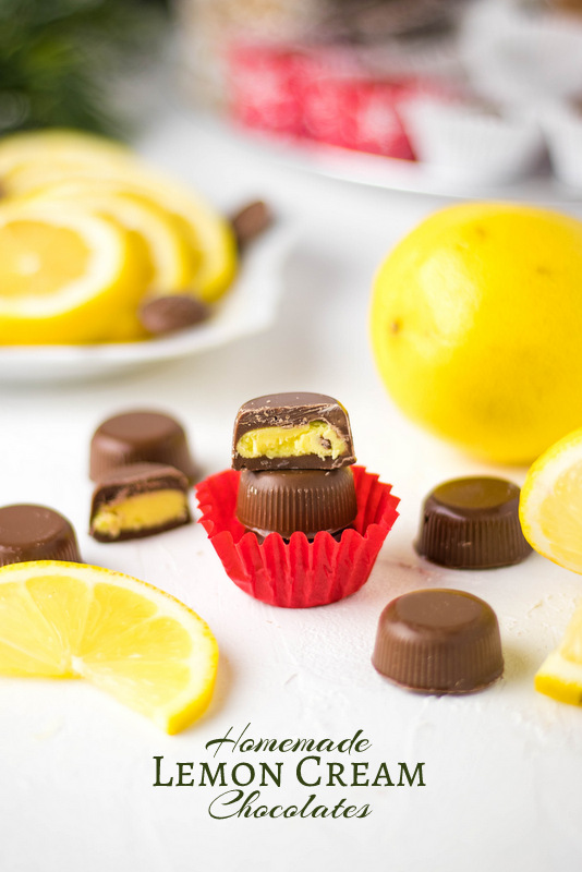 Christmas chocolates with lemon cream cut open to see yellow filling.